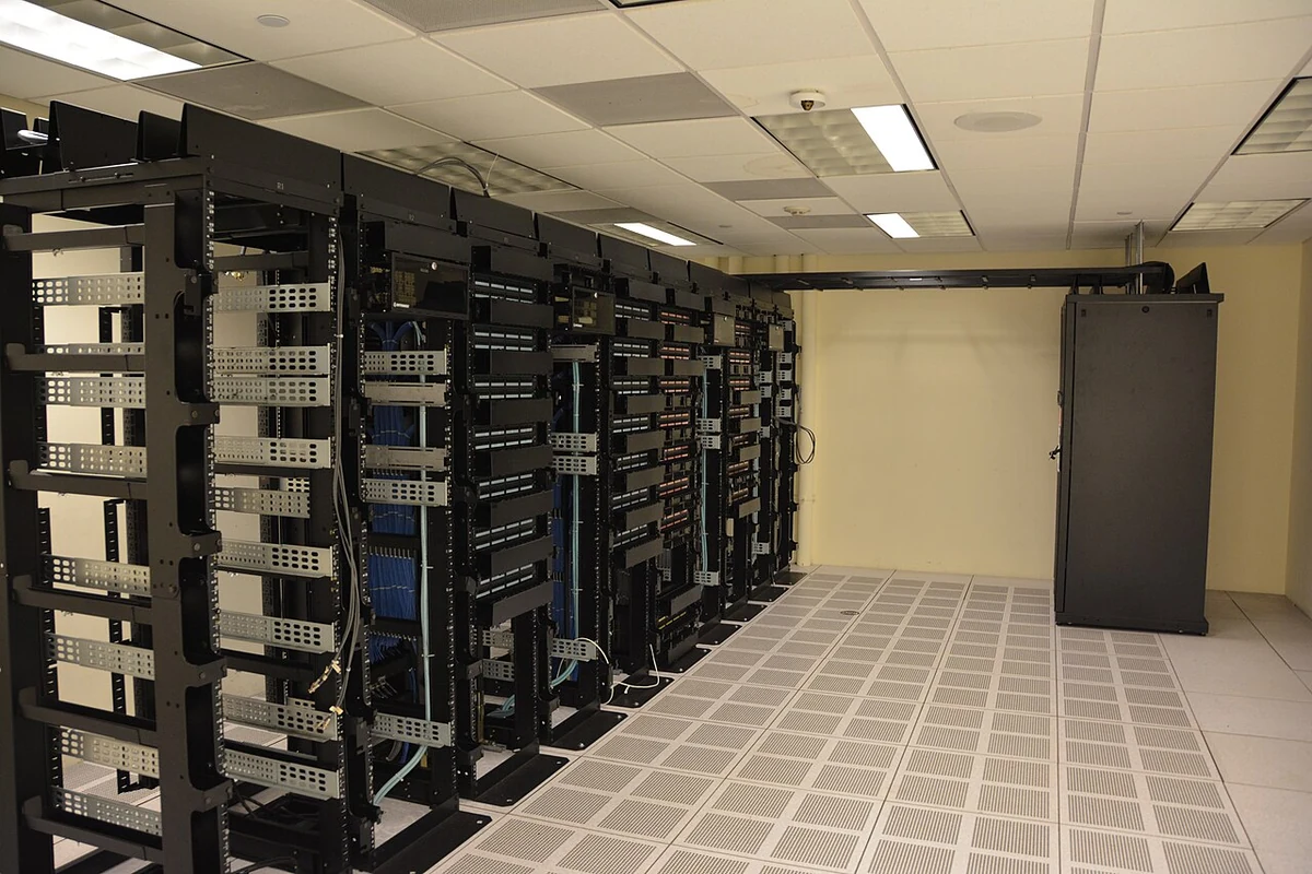 Rows of server cabinets inside a data center.