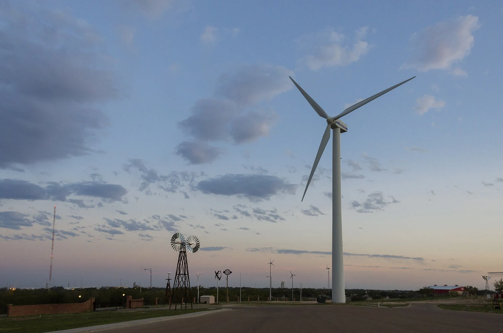Una turbina eólica y un molino en Texas como ilustración de archivo de generación junto a un campus de datos