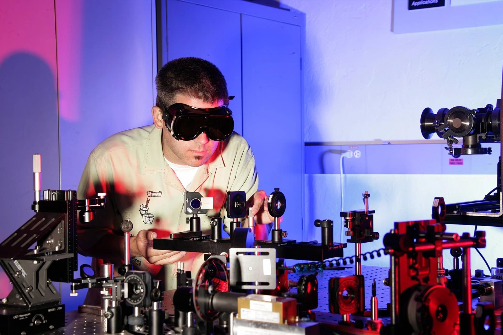 Archive laser optics laboratory photograph at Idaho National Laboratory; thematic illustration of photonics research