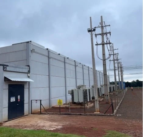 Contextual photo of the exterior infrastructure at HIVE Digital’s Yguazú mining site; not documentation of a network outage.
