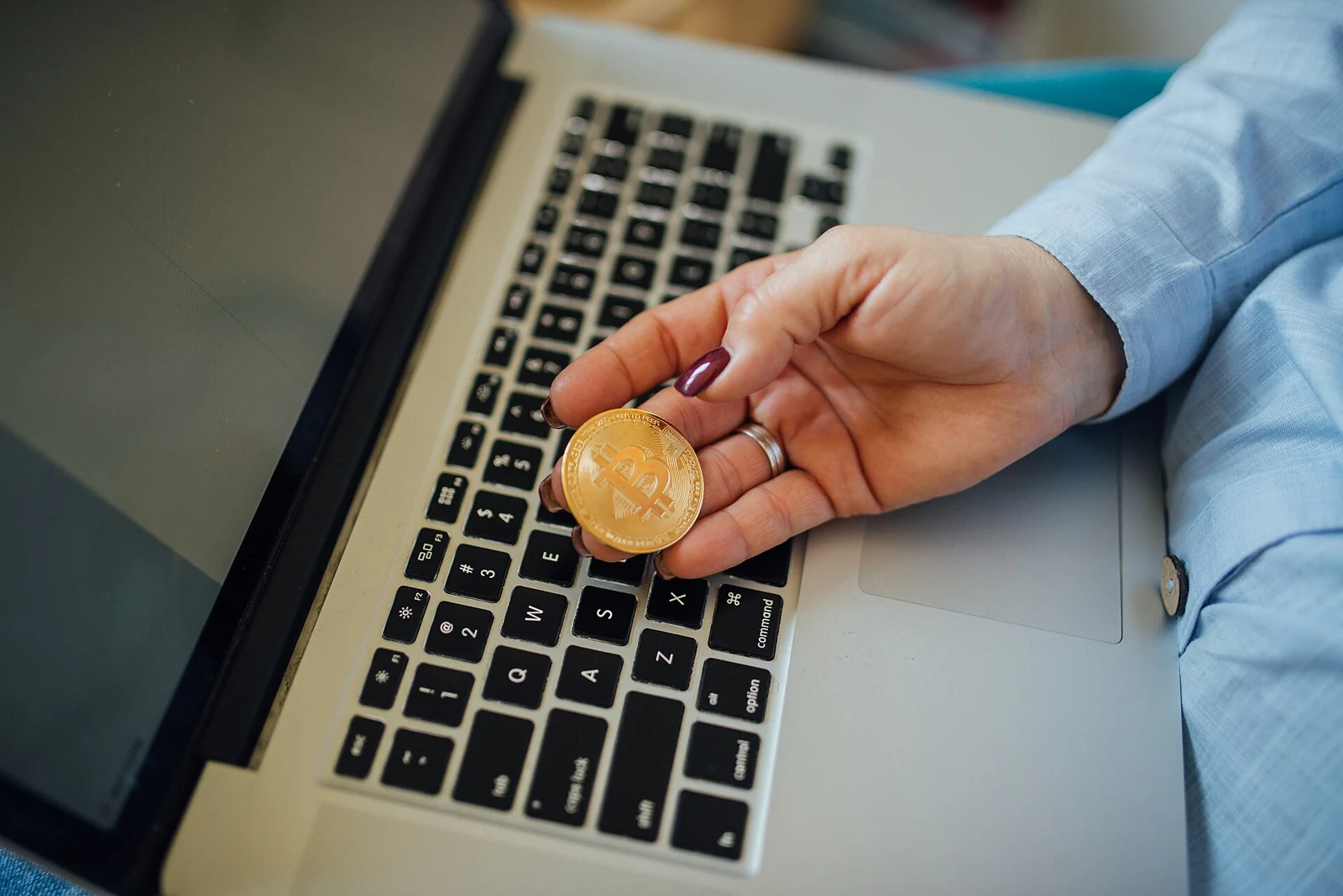 Physical Bitcoin token and laptop; thematic image, not Bitcoin Core software